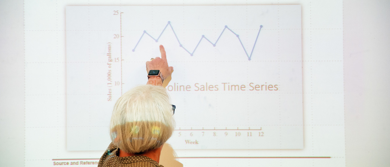 Instructor pointing to a graph in a business analytics class